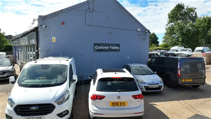 Cars parked in the customer parking area outside the Fairlee workshop