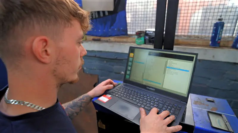 A Fairlee technician reviewing details on a laptop in the workshop