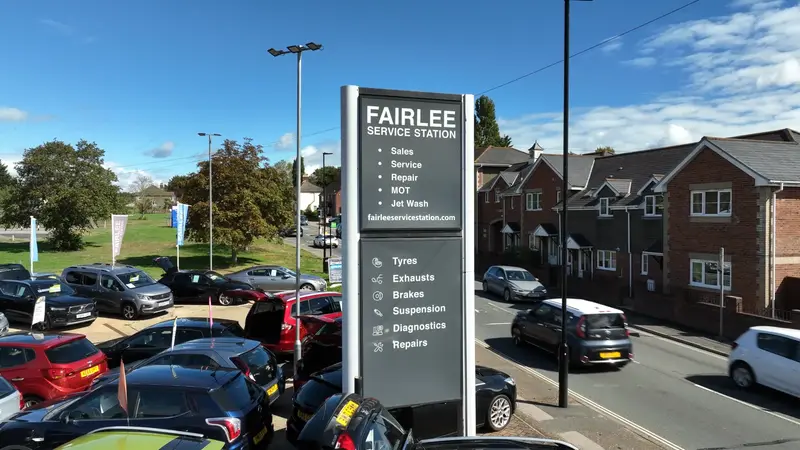 The tall Fairlee Service Station sign beside the car sales forecourt on Fairlee Road, Newport
